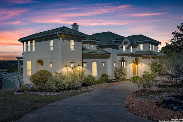 mediterranean / spanish-style house featuring central air condition unit