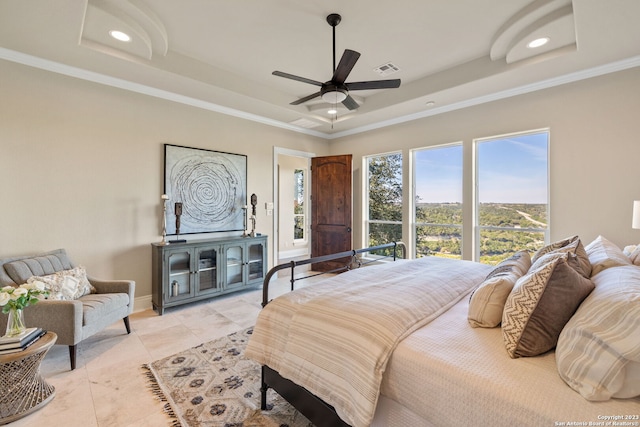 tiled bedroom featuring ceiling fan, a raised ceiling, and ornamental molding