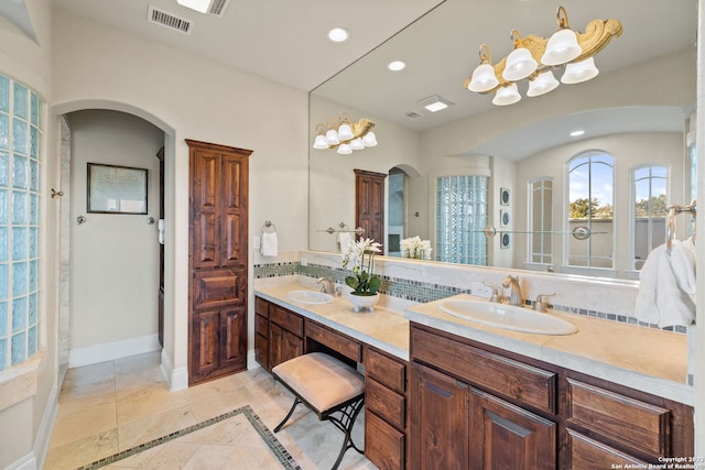 bathroom with backsplash, dual bowl vanity, and tile floors