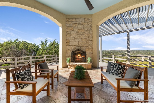 view of terrace with an outdoor living space with a fireplace