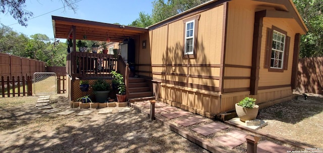 view of side of home with a deck