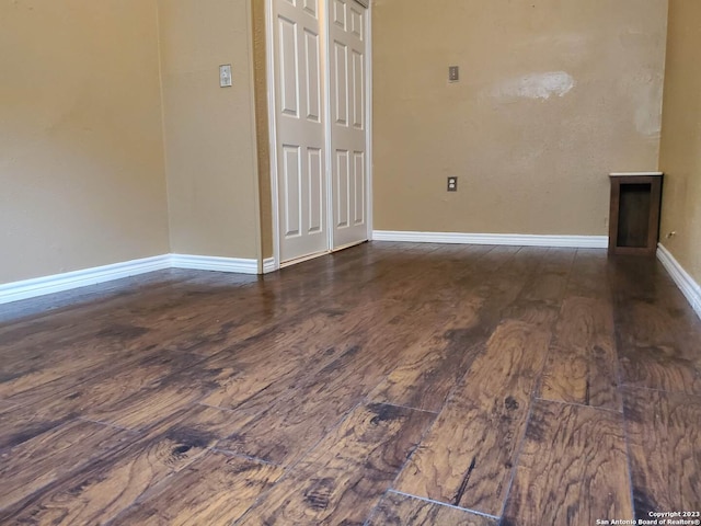 unfurnished room with dark hardwood / wood-style flooring