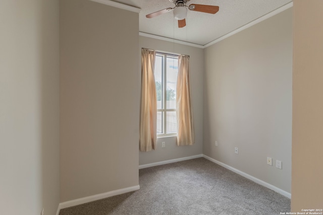 spare room featuring light carpet, crown molding, and ceiling fan