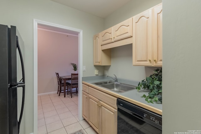 kitchen with light brown cabinets, light tile floors, black appliances, and sink