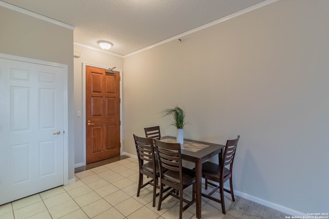 tiled dining area with a textured ceiling and crown molding