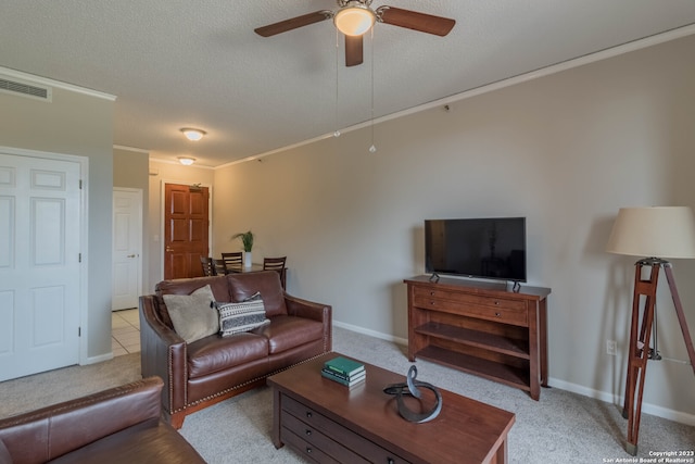 carpeted living room featuring ornamental molding, a textured ceiling, and ceiling fan