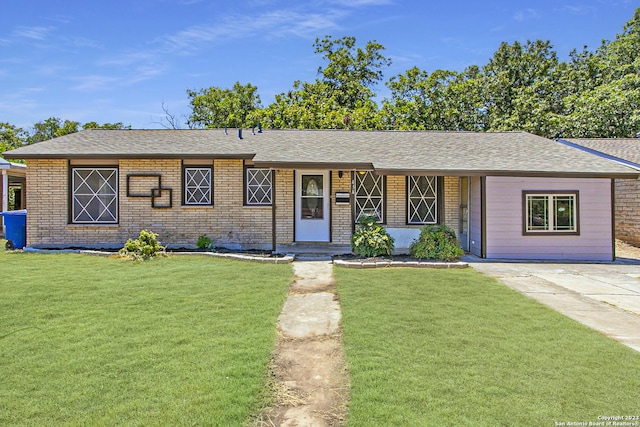 434 Kate Schenck Ave, San Antonio, TX 78223 - ranch-style home featuring a front lawn, a shingled roof, and brick siding