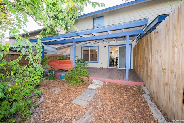 back of house with a deck and a pergola