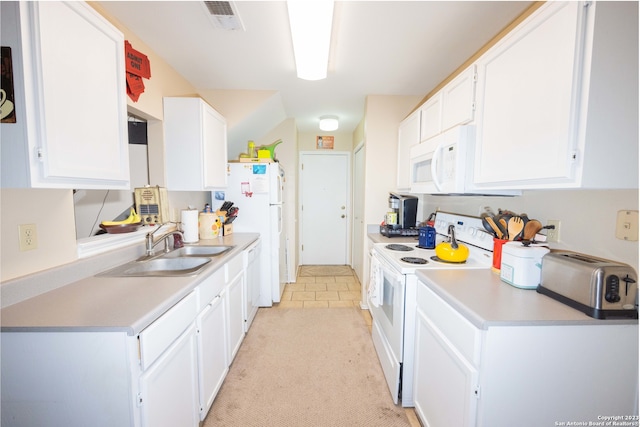 kitchen with white cabinetry, white appliances, and sink