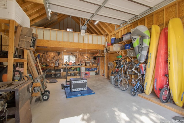 garage with a workshop area and a garage door opener