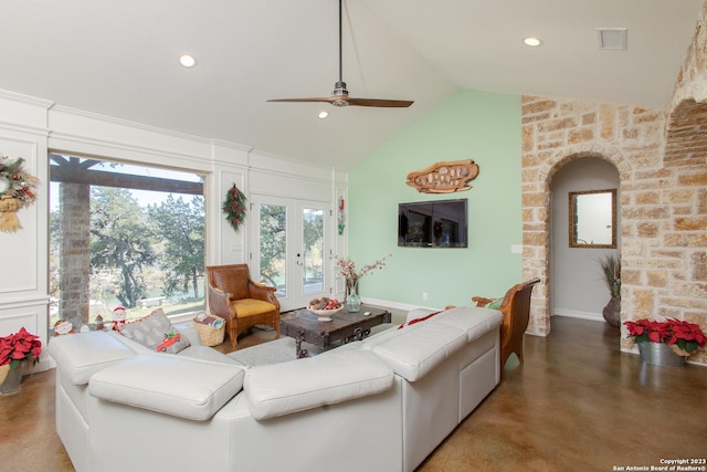 living room with ceiling fan, french doors, concrete flooring, and vaulted ceiling