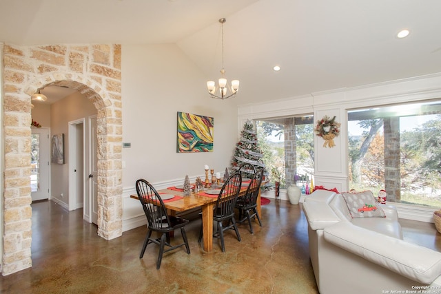 dining room with lofted ceiling and an inviting chandelier