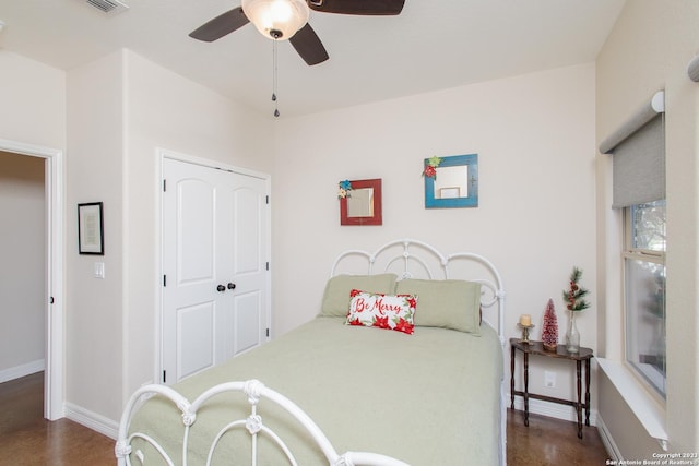 bedroom featuring dark hardwood / wood-style flooring, ceiling fan, and a closet