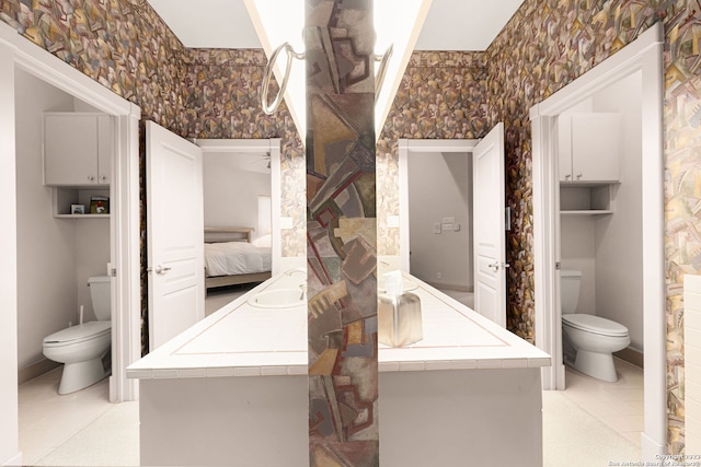 bathroom featuring tile patterned flooring, vanity, and toilet