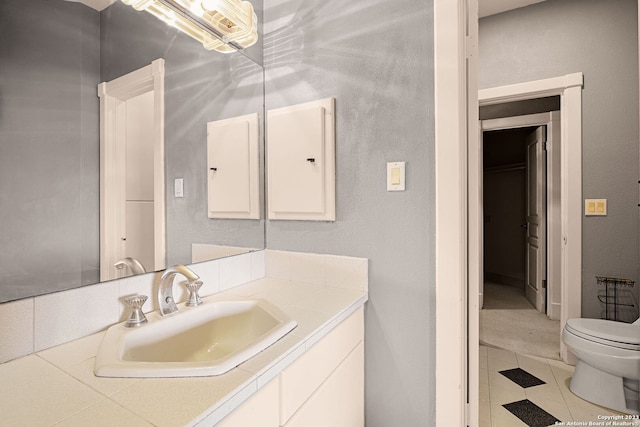 bathroom featuring tile patterned floors, vanity, and toilet