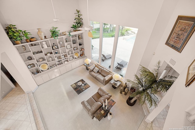 tiled living room featuring ceiling fan