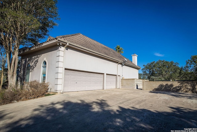 view of side of property with a garage