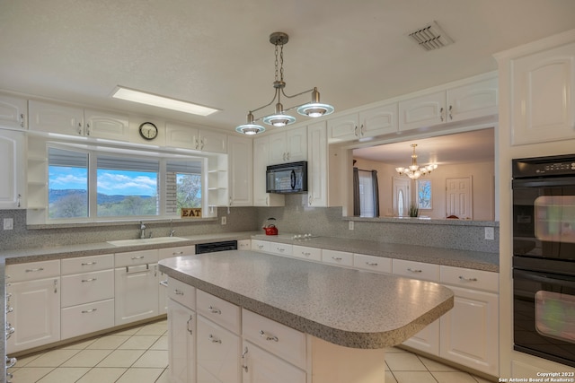 kitchen featuring hanging light fixtures, sink, backsplash, and black appliances