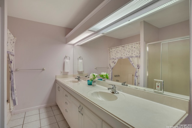 bathroom with tile floors, dual sinks, and large vanity