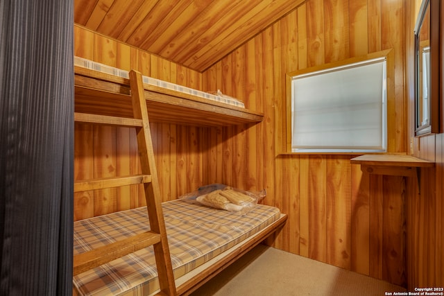 bedroom with wooden ceiling and wood walls