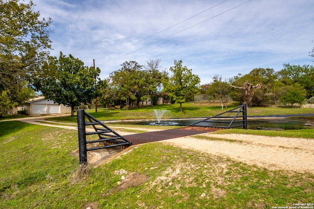 view of home's community with a garage and a yard