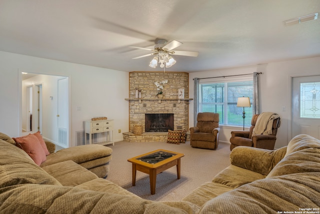 living room featuring carpet, ceiling fan, and a fireplace