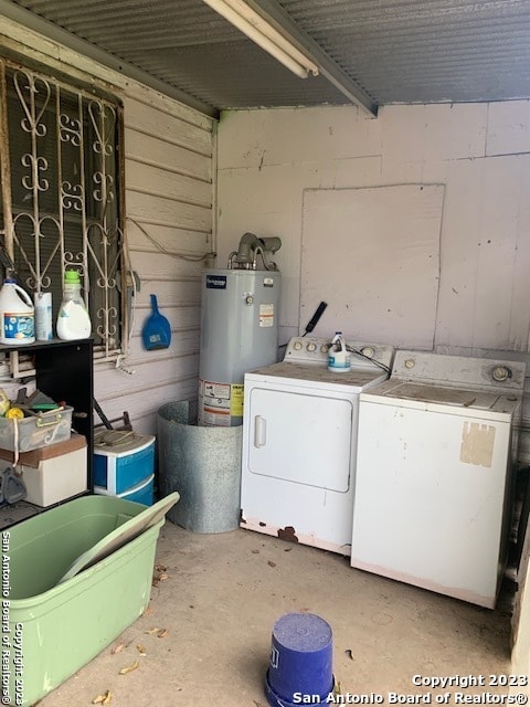 clothes washing area featuring separate washer and dryer and gas water heater