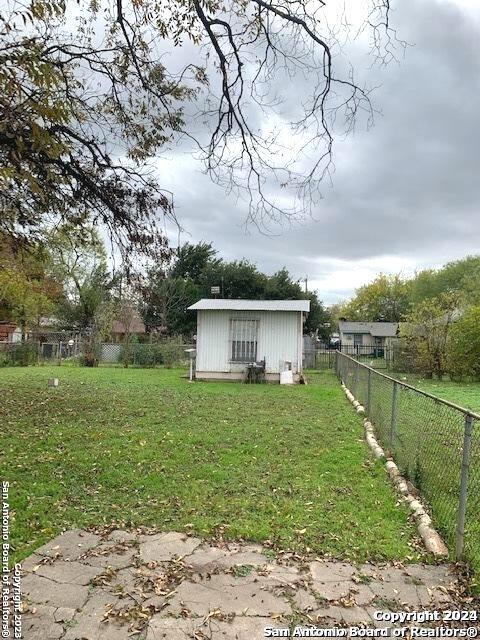 view of yard with an outbuilding and a fenced backyard