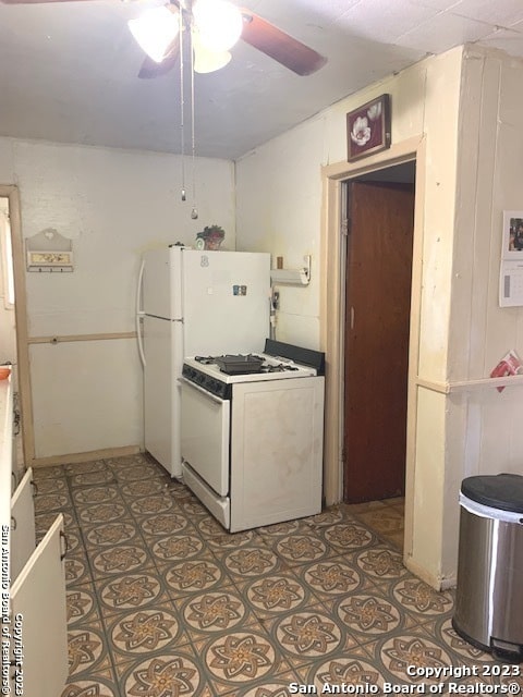 kitchen featuring tile floors, white range with gas stovetop, and ceiling fan