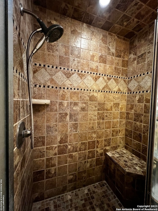 bathroom with tiled shower