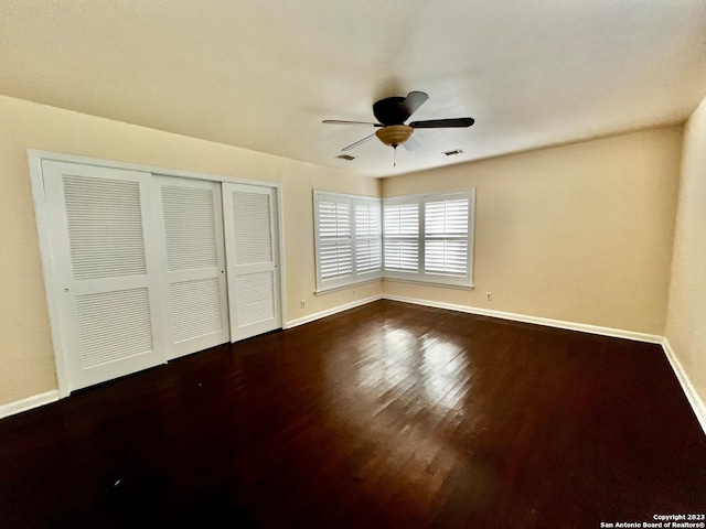 unfurnished bedroom featuring a closet, hardwood / wood-style flooring, and ceiling fan