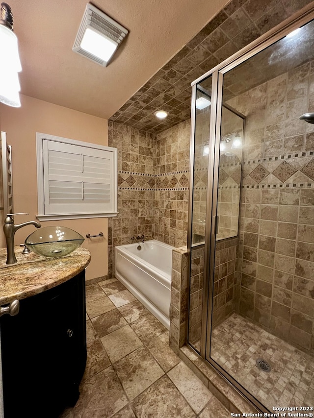 bathroom with vanity, plus walk in shower, and tile patterned flooring