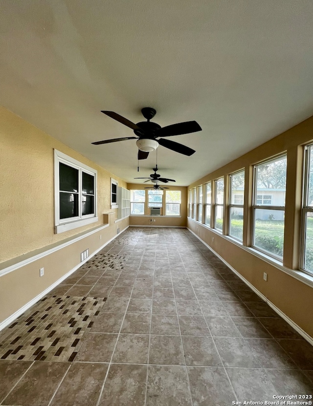 exterior space featuring ceiling fan