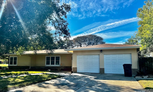 single story home featuring a garage and a front yard