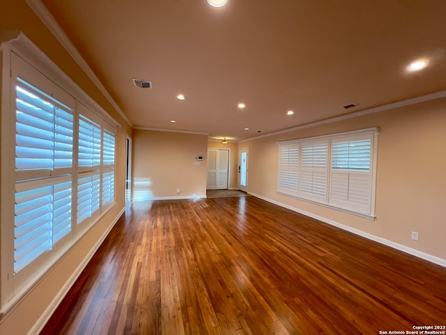 spare room with crown molding and hardwood / wood-style floors