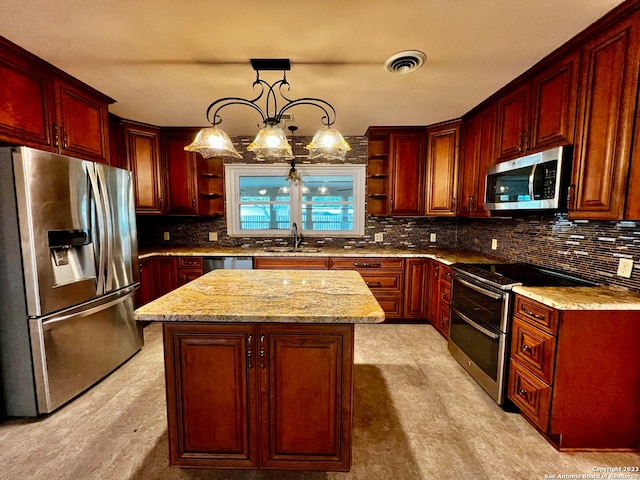 kitchen featuring sink, decorative backsplash, pendant lighting, and stainless steel appliances