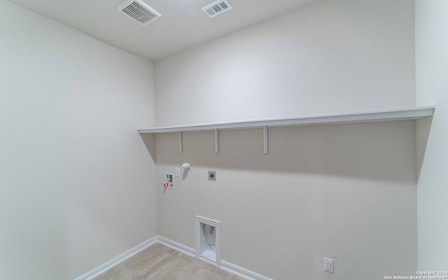 washroom featuring hardwood / wood-style flooring, hookup for an electric dryer, washer hookup, and hookup for a gas dryer