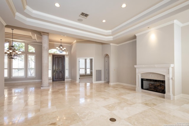 unfurnished living room featuring a tray ceiling, visible vents, a notable chandelier, and a premium fireplace