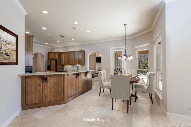 kitchen with arched walkways, brown cabinetry, black fridge with ice dispenser, ornamental molding, and an inviting chandelier