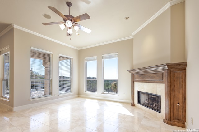 unfurnished living room with ceiling fan, a tiled fireplace, light tile floors, and ornamental molding