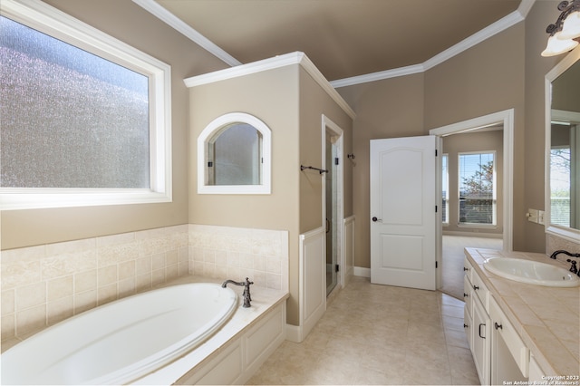 bathroom with tile flooring, ornamental molding, a bath, and vanity