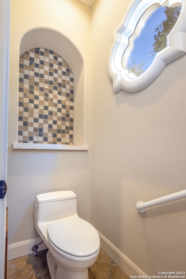 bathroom with tile floors and toilet