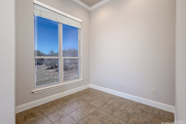 tiled spare room featuring ornamental molding