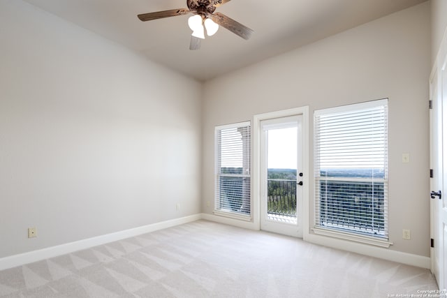 unfurnished room with ceiling fan and light colored carpet