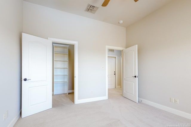 unfurnished bedroom featuring a ceiling fan, visible vents, light carpet, and baseboards