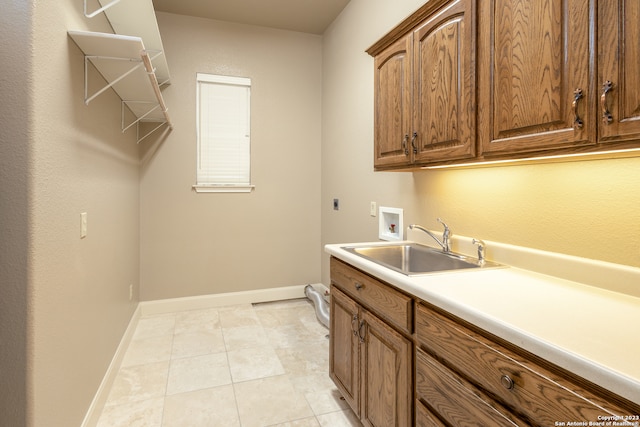 washroom with cabinets, washer hookup, hookup for an electric dryer, sink, and light tile floors