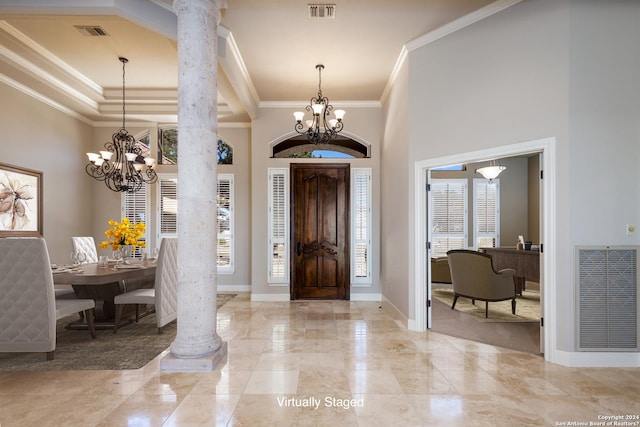 foyer with visible vents, a notable chandelier, and decorative columns