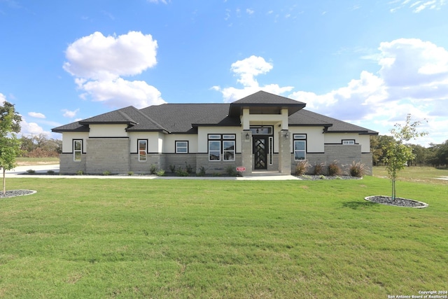 prairie-style house featuring a front lawn