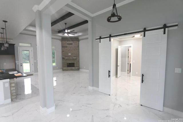 interior space with ornamental molding, a barn door, and beam ceiling