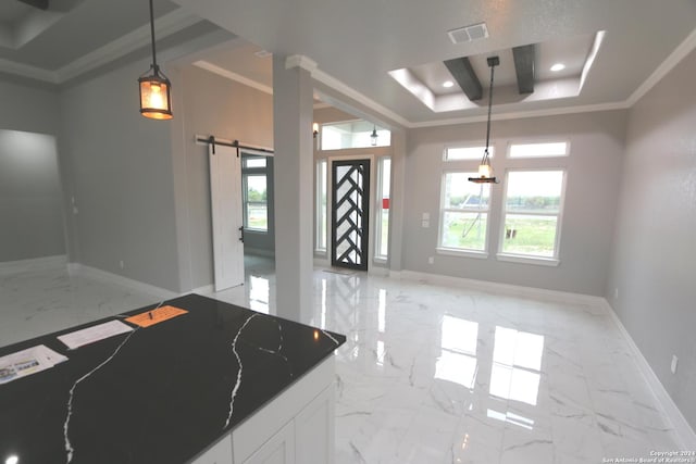 kitchen with white cabinetry, dark stone counters, hanging light fixtures, a tray ceiling, and crown molding